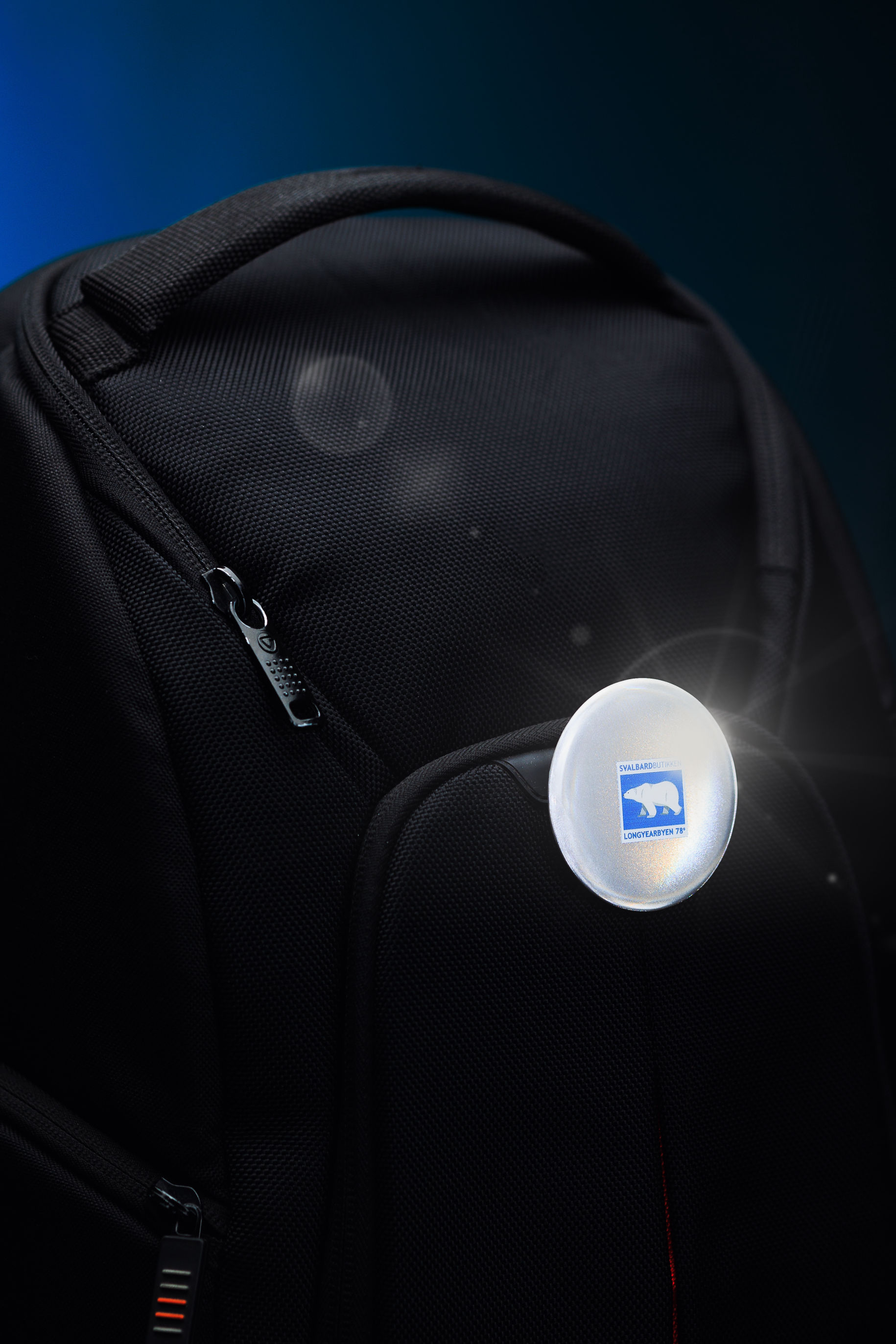 Branded button on backpack