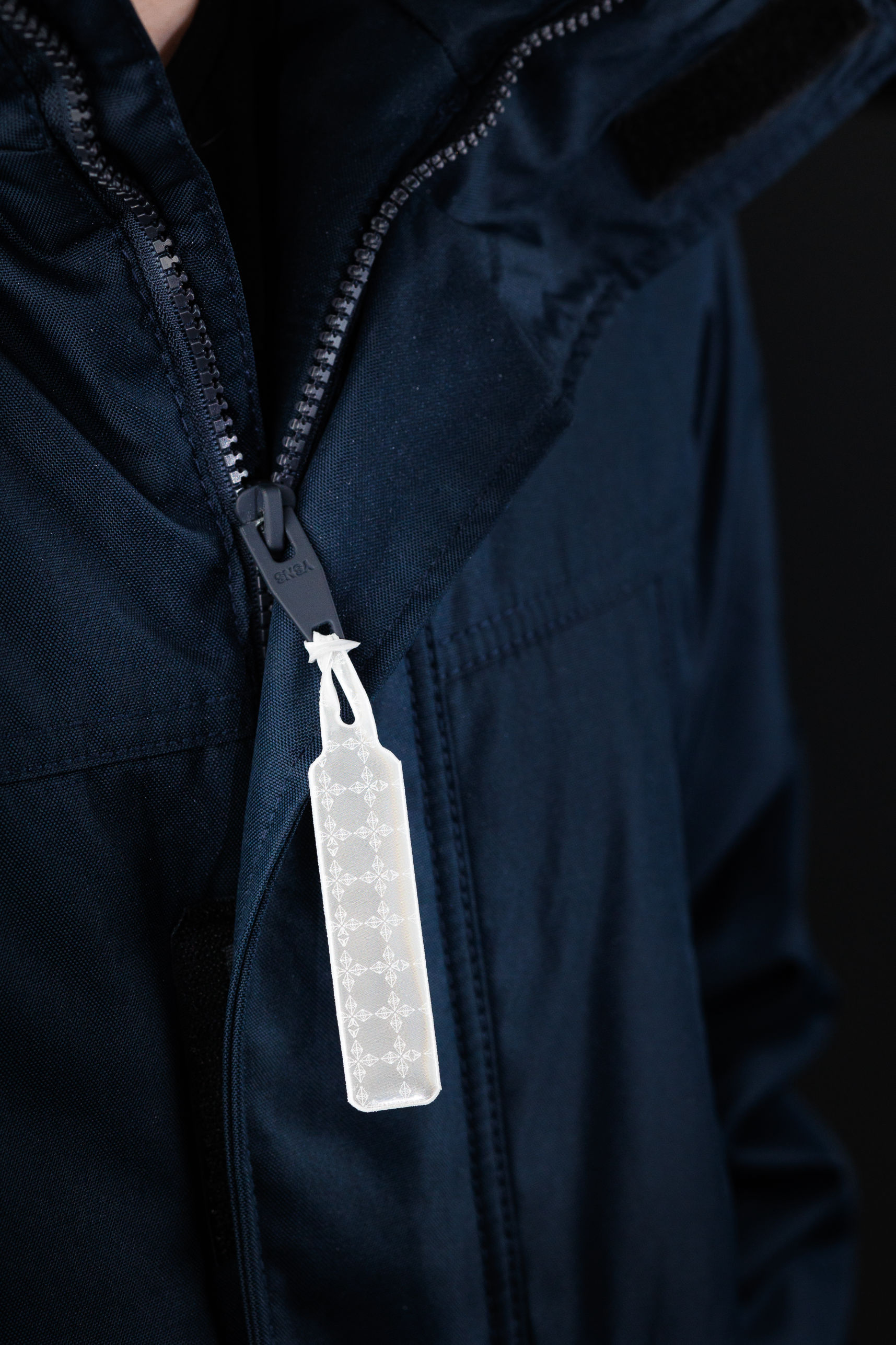 Jacket with reflective zip puller